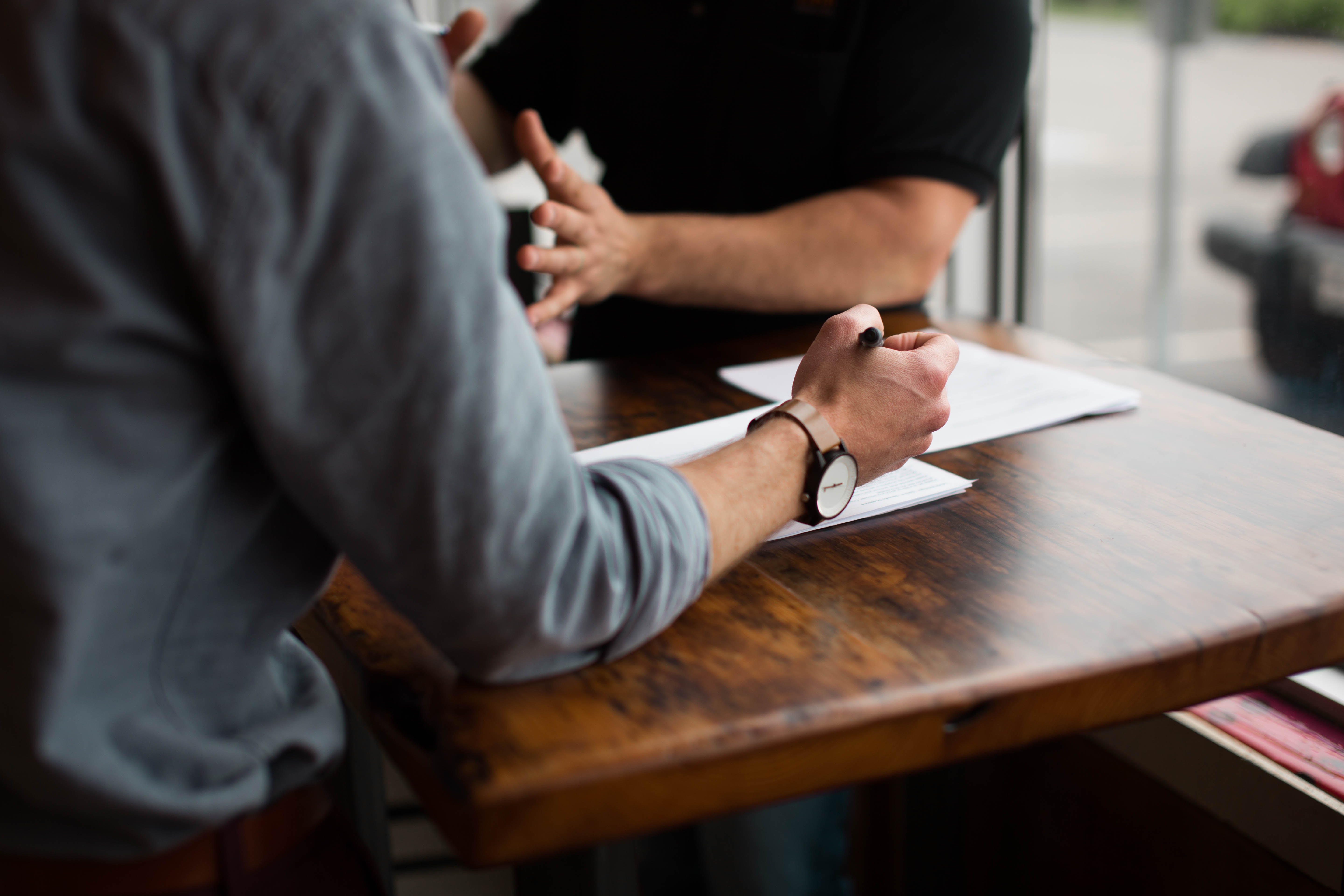 Man sitting at table reviewing a paper