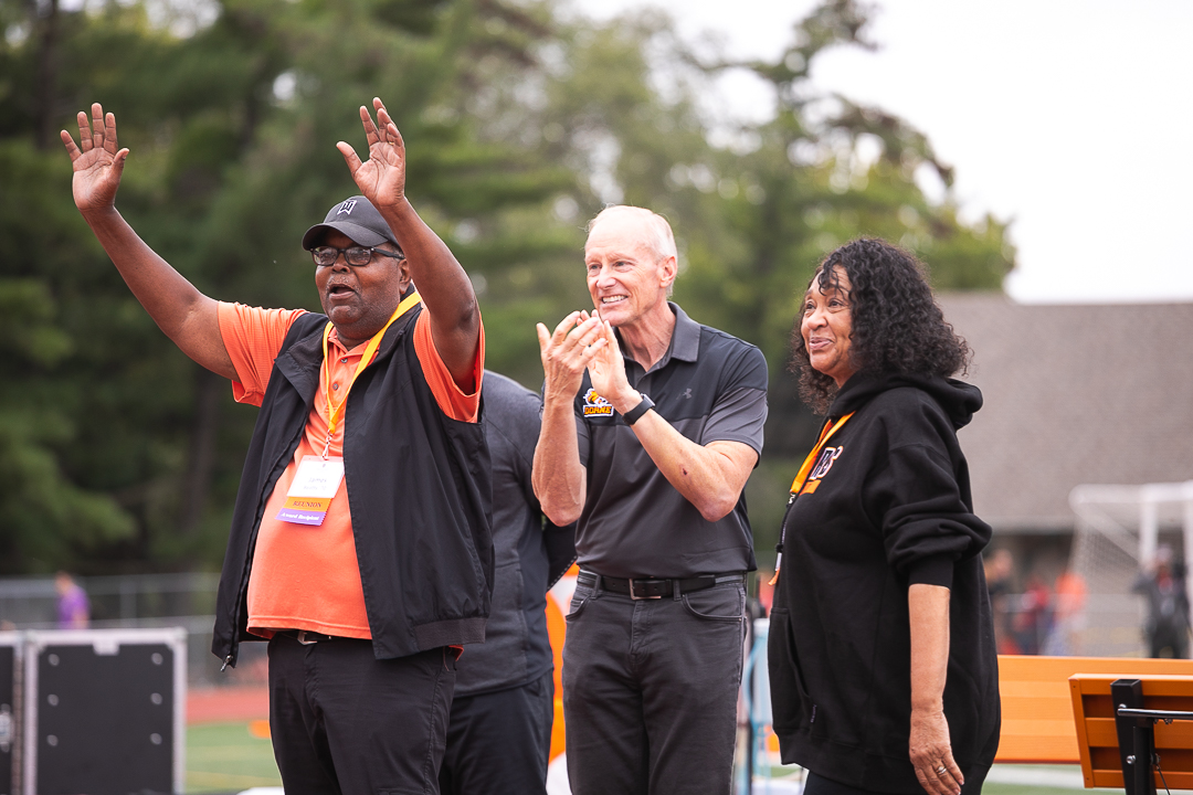 Alumni and Dr. Hughes cheering