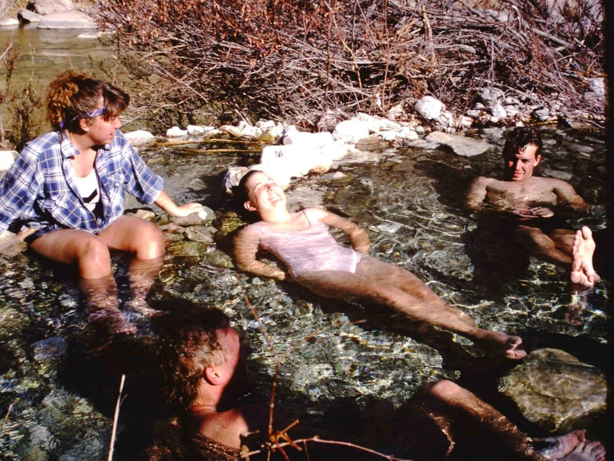 Students lounge in a natural hot spring along the Rio Grande during an interterm canoeing trip.