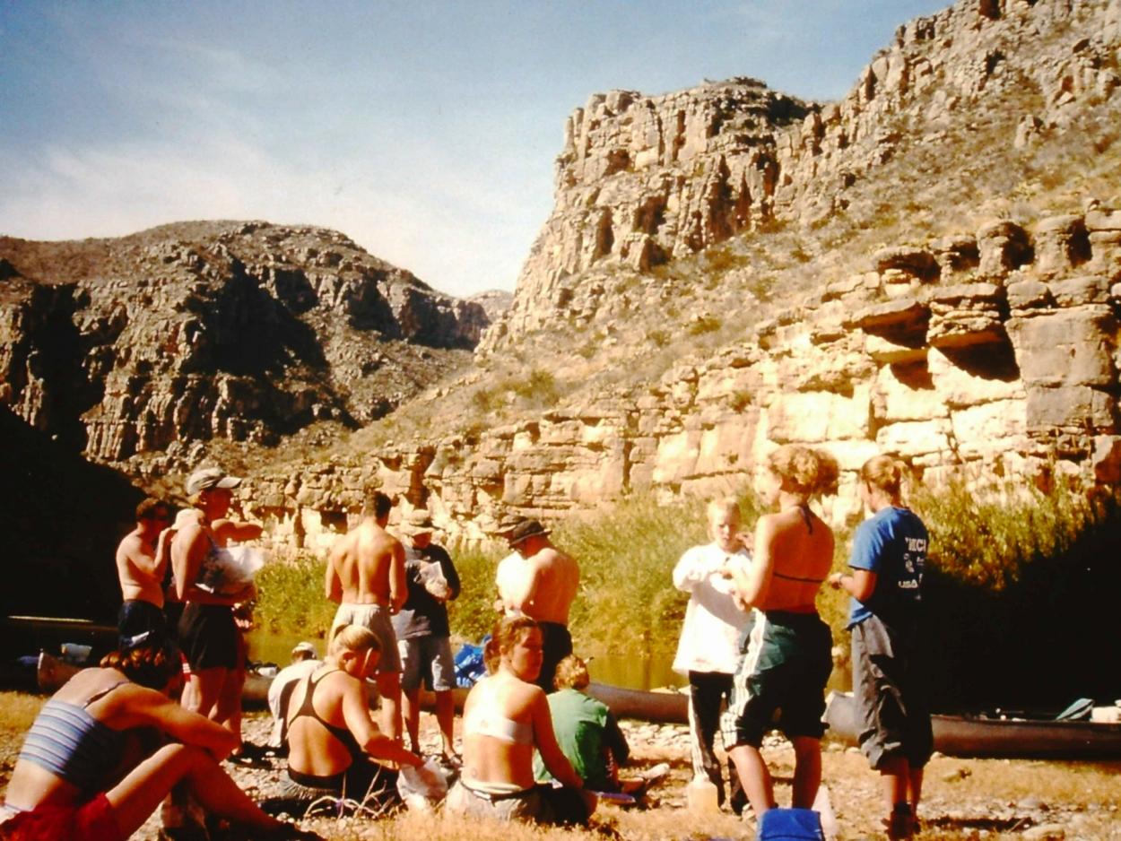 Students take a break along the banks of the Rio Grande during an interterm trip.