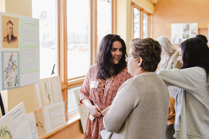 Doane University student Marilu Garcia and her family view an exhibit on artist Mary Doane at Spring Creek Prairie Audubon Center. 