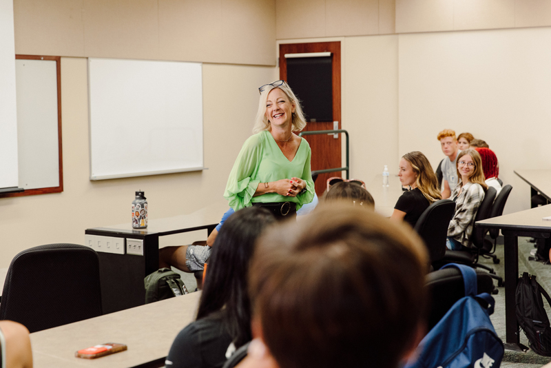 Teacher smiling while teaching an in-person class