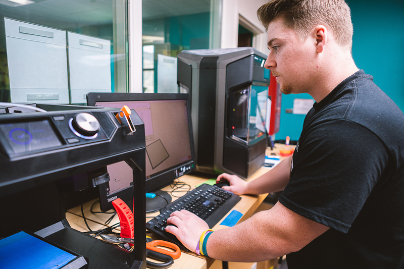 Student working with specialized engineering equipment in a lab setting