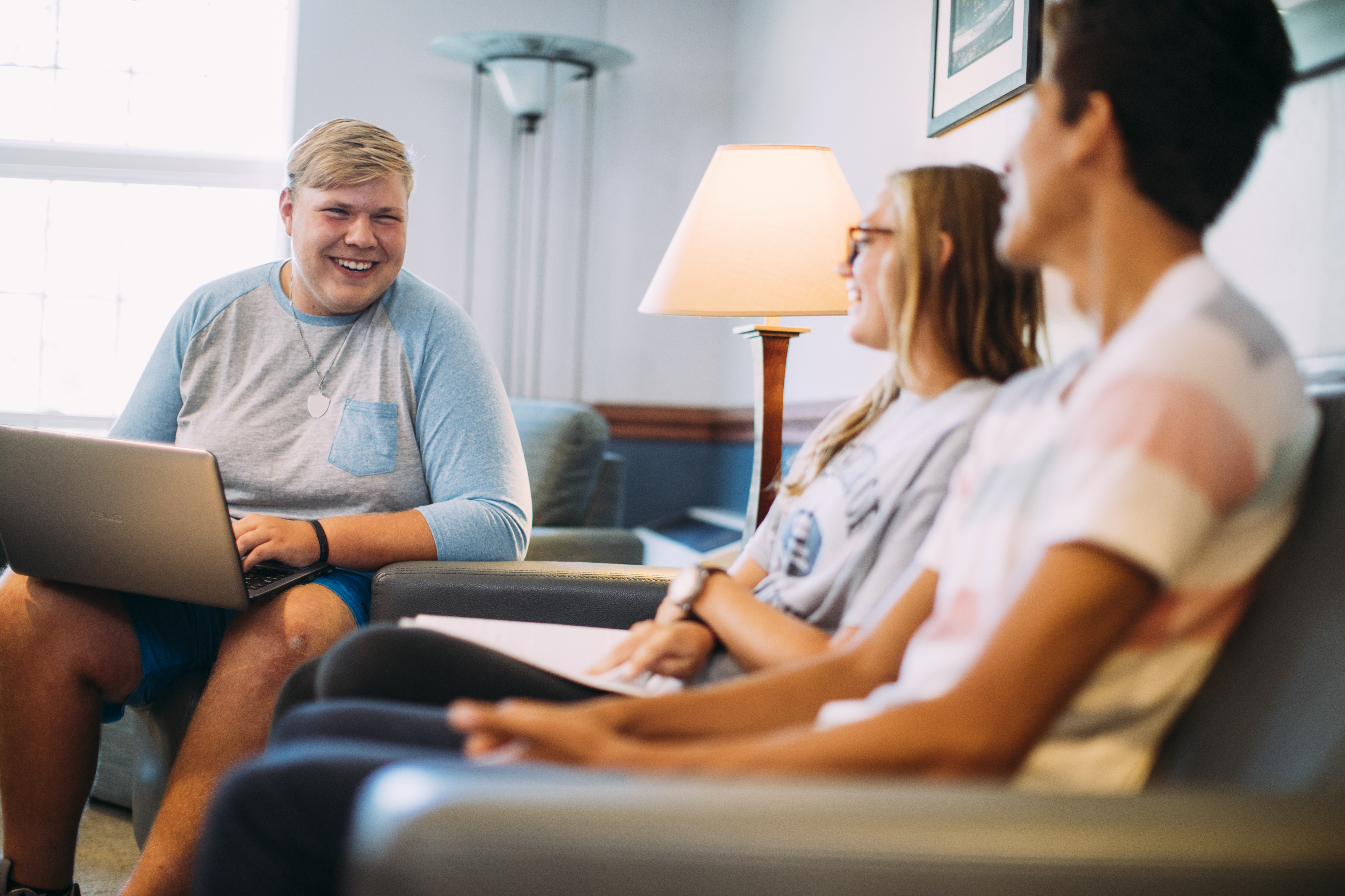 college students sitting and having a conversation in a living room.