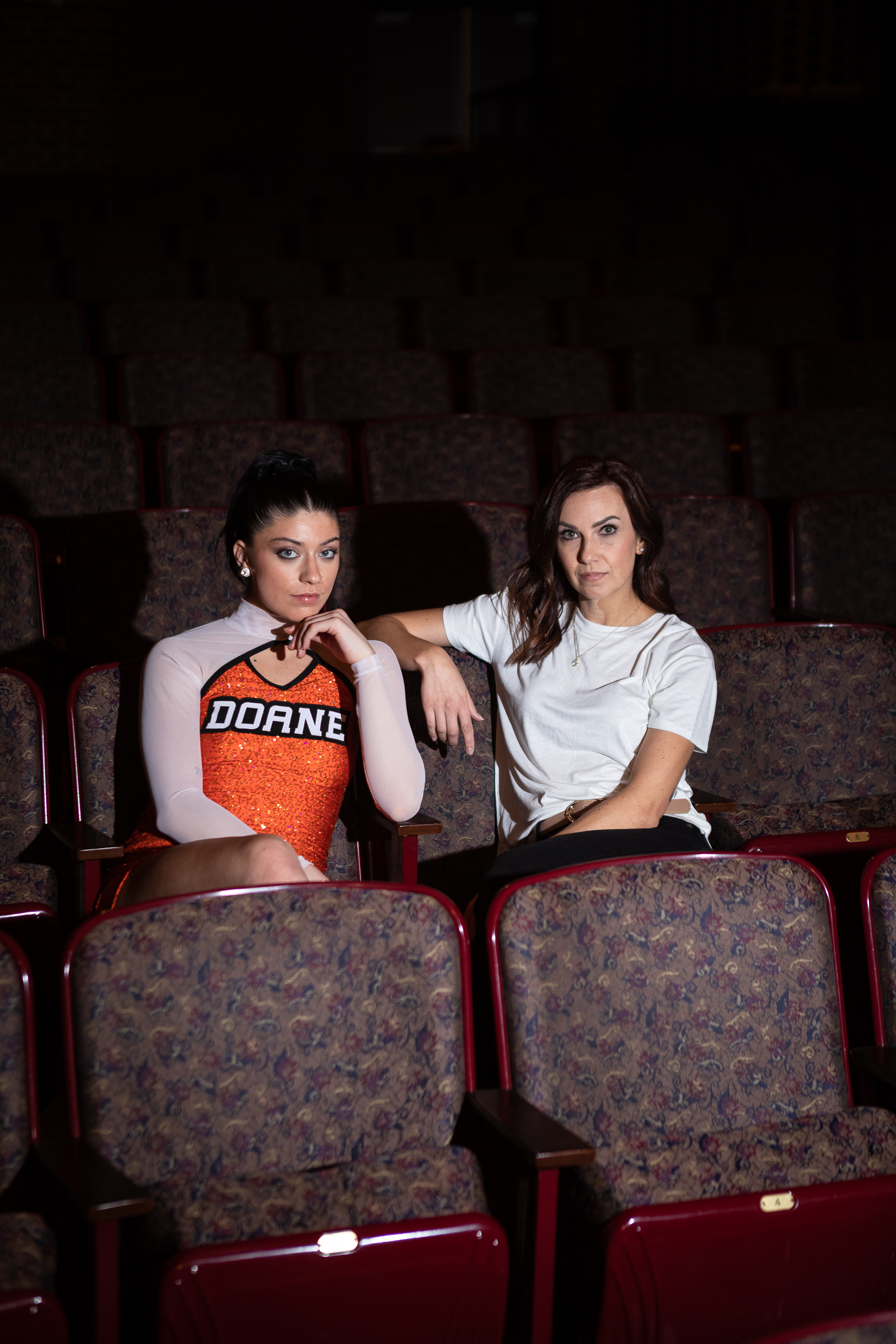 Kelsey Brady and Ashley Lyon sit in Heckman Auditorium