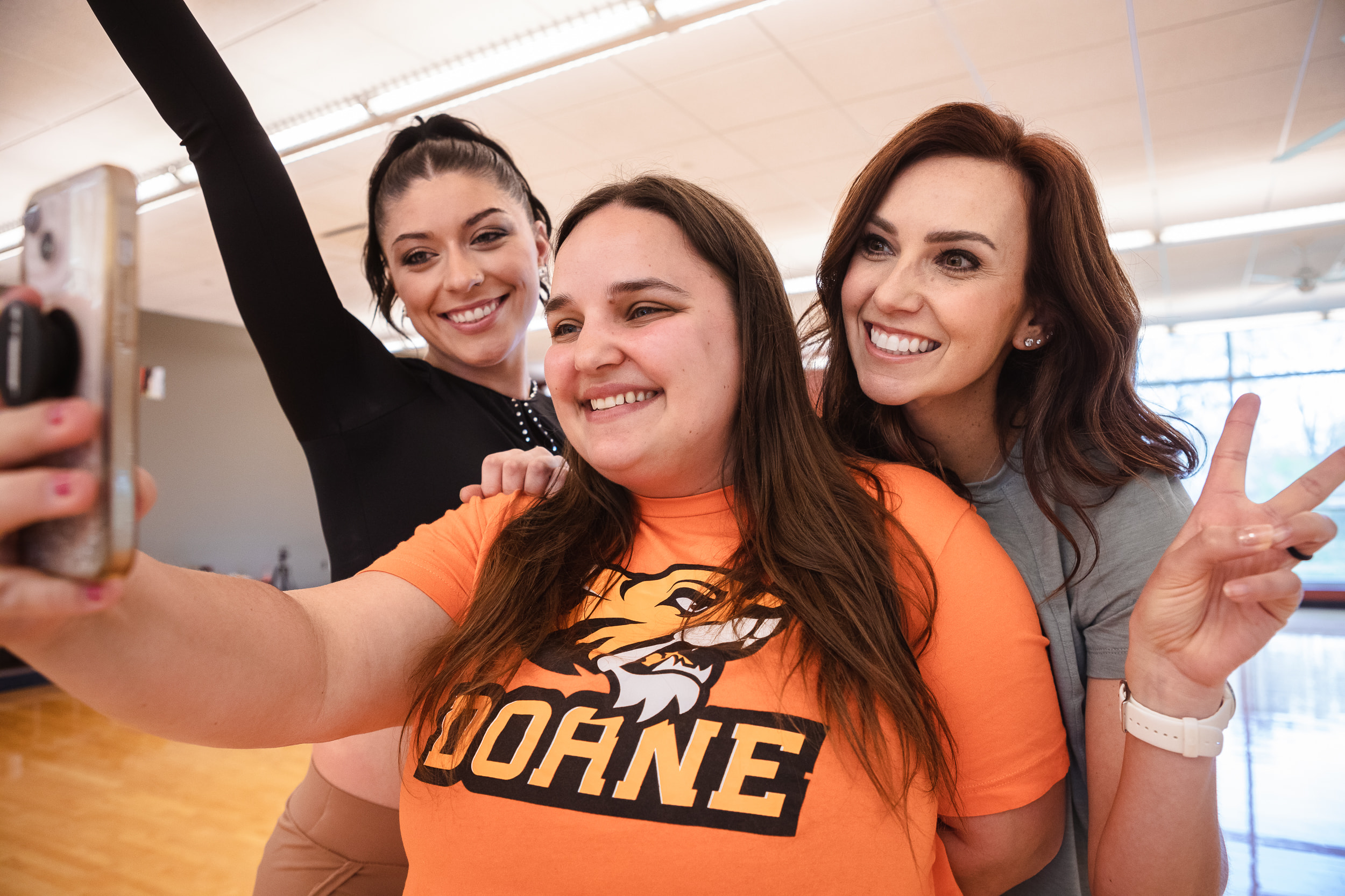 Doane students and professor taking selfies.