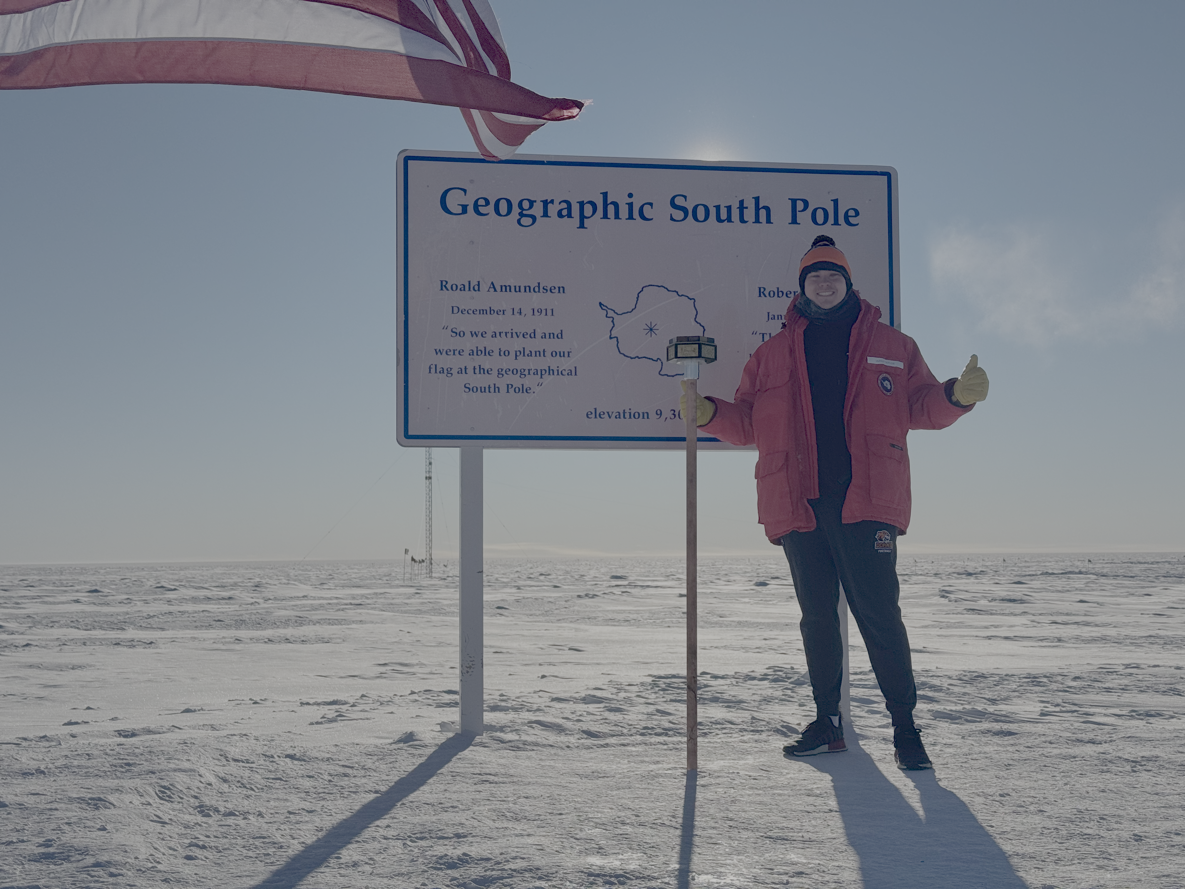 Jared Taylor stands at the geographic South Pole