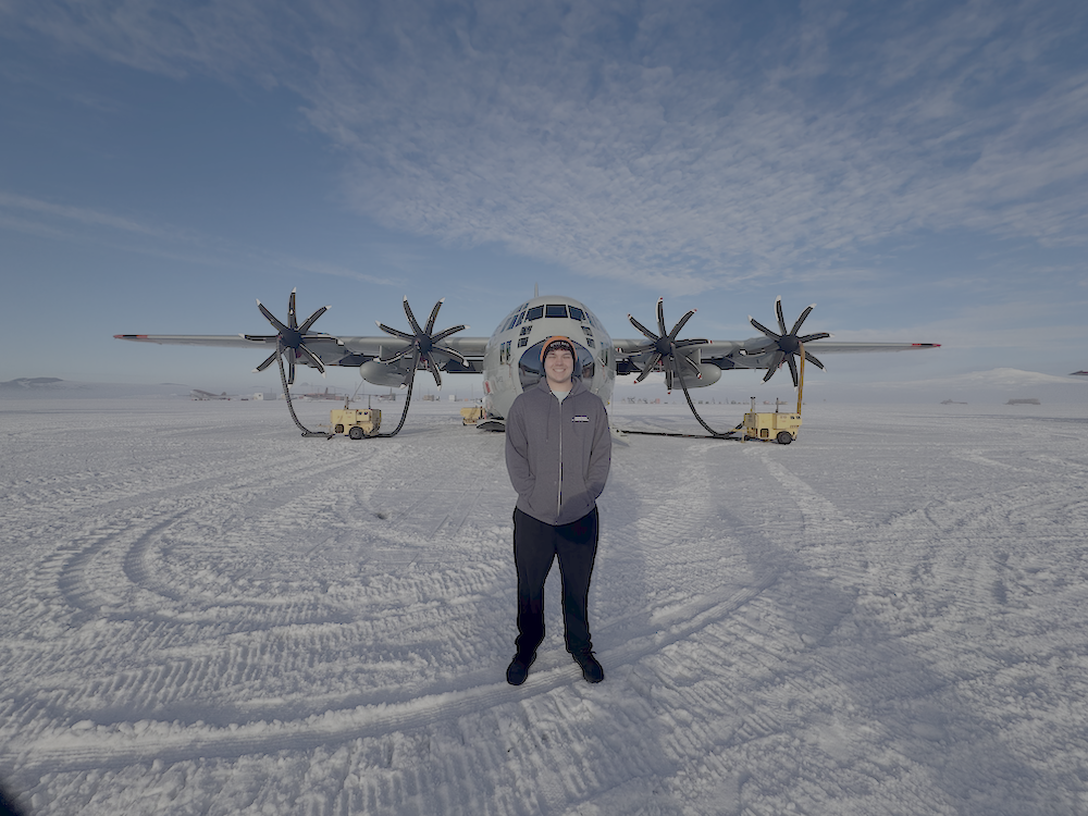 Jared Taylor at Willy Field in front of a c-130