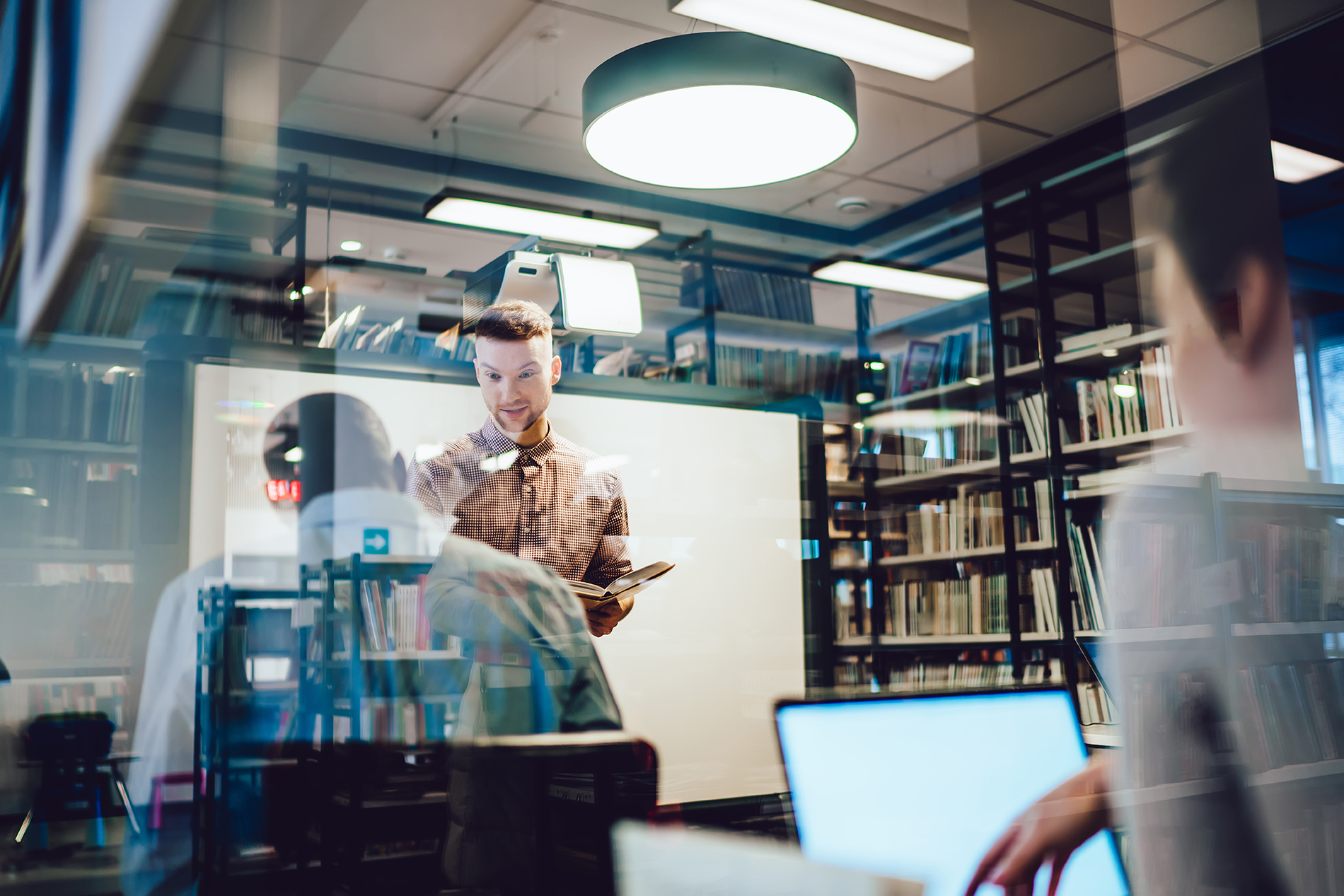 A teacher teaching in a library.