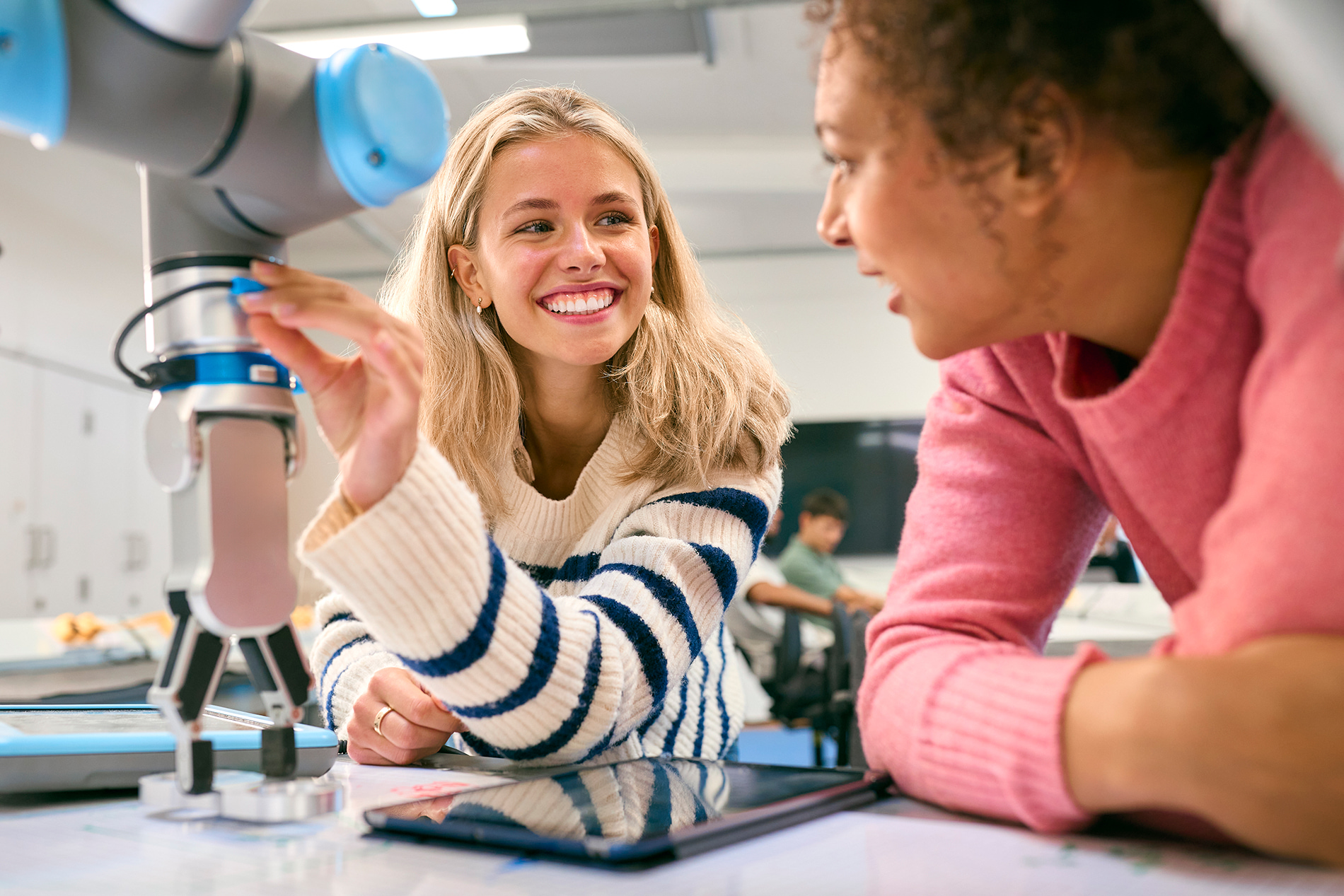A teacher and student using a microscope.