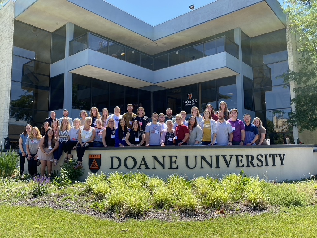 Image of Dr. Bess Scott (middle) and the 47th cadre of Master of Education — Educational Leadership students in front of the Fred Brown Center on Doane's Lincoln campus location. 