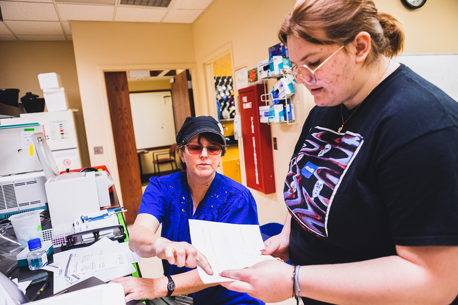 Dr. Kate Marley (left) and McKenna Revis ’24 review data from their research on tumor development in breast cancer. Students Revis, Sam Collins ’26 and JaDae Moore ’25 are working with Marley throughout the summer to research breast cancer tumor development. 