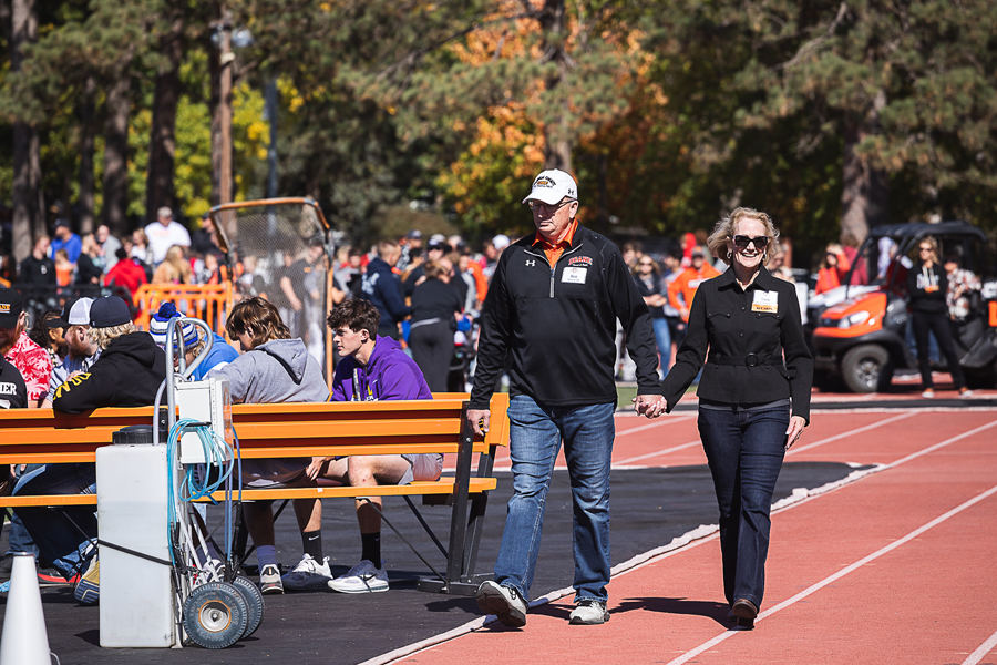 Ken ’85 and Tami Wolfe ’82  Marvin, winners of Doane’s Honor D alumni award, walk along the track surrounding Al Papik Field during halftime of the Oct. 8 Homecoming football game to be recognized by Dr. Roger Hughes, Doane’s president, and Mark Wateska, athletic director.