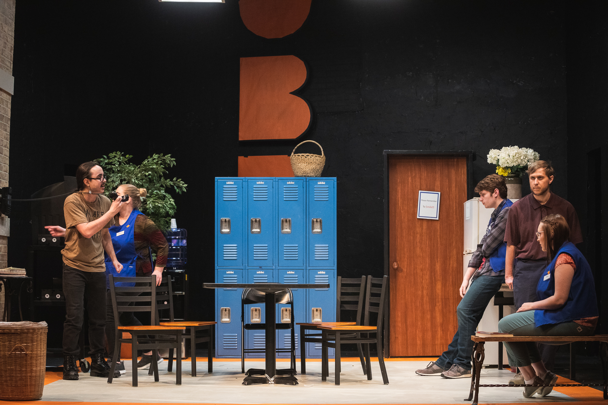 Image of the set and cast of Doane's production of "A Bright New Boise." The majority of the play takes place in the break room of a large arts and crafts store in Idaho.