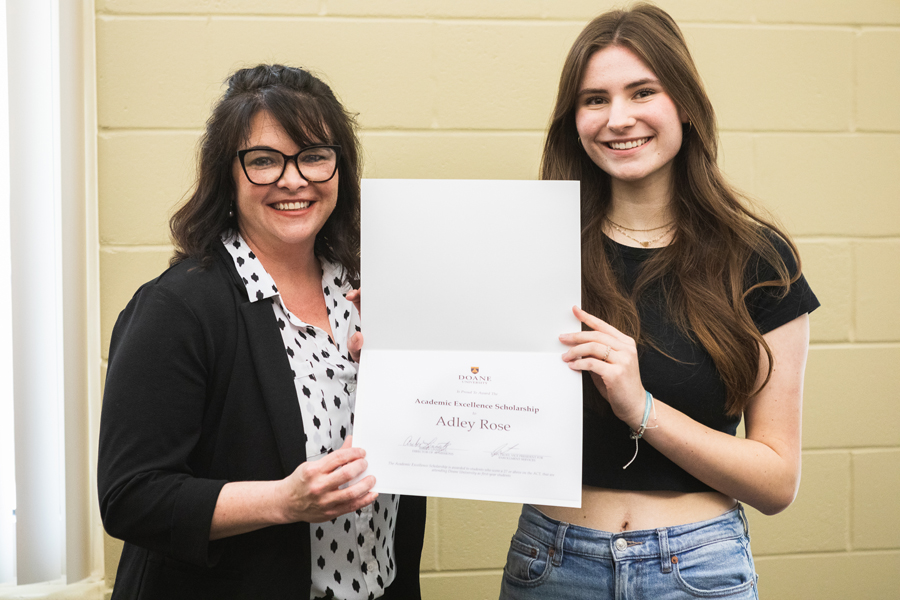 Adley Rose (right) holds up her Academic Excellence Scholarship award certificate with Jessica Pulte, Doane recruiter who covers the Omaha metro. 