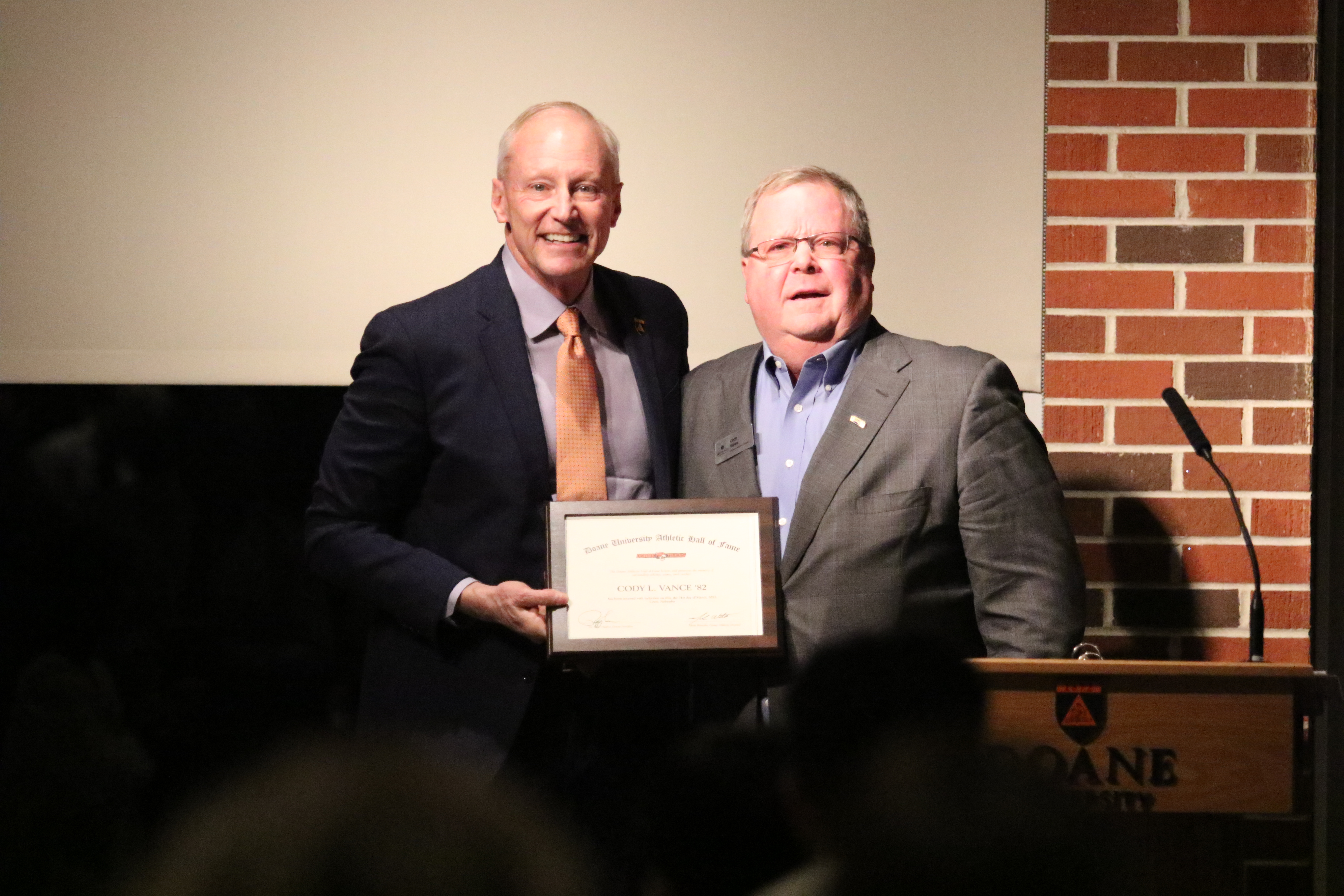 Cody Vance stands next to President Roger Hughes during the Doane Hall of Fame Class of 2023 Ceremony