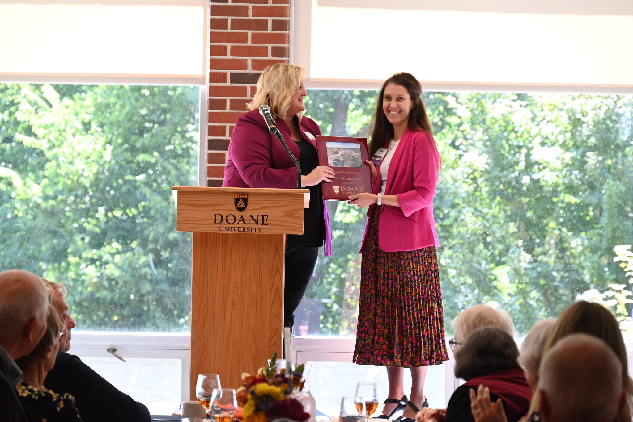 Nicole Tegtmeier Lawson receives a plaque from Anne Ziola, director of human resources at Doane. 