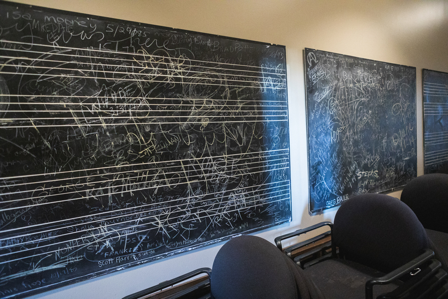 Image of old blackboards in the Whitcomb Lee Conservatory. The boards are covered in old chalk, the names of students long since graduated, inside jokes, etc. 