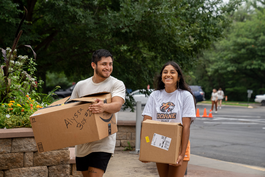 Doane senior Arturo Salinas helps his sister, Alyssa, move boxes into the residence hall during the university’s move-in day for first-year students. 