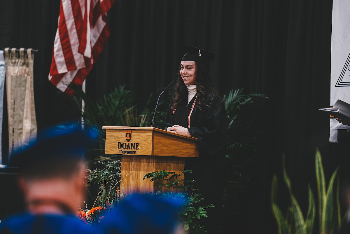 Mya Williams ’22 smiles after singing the "Doane Hymn" to graduates and attendees at Doane's 2022 winter commencement ceremony. 