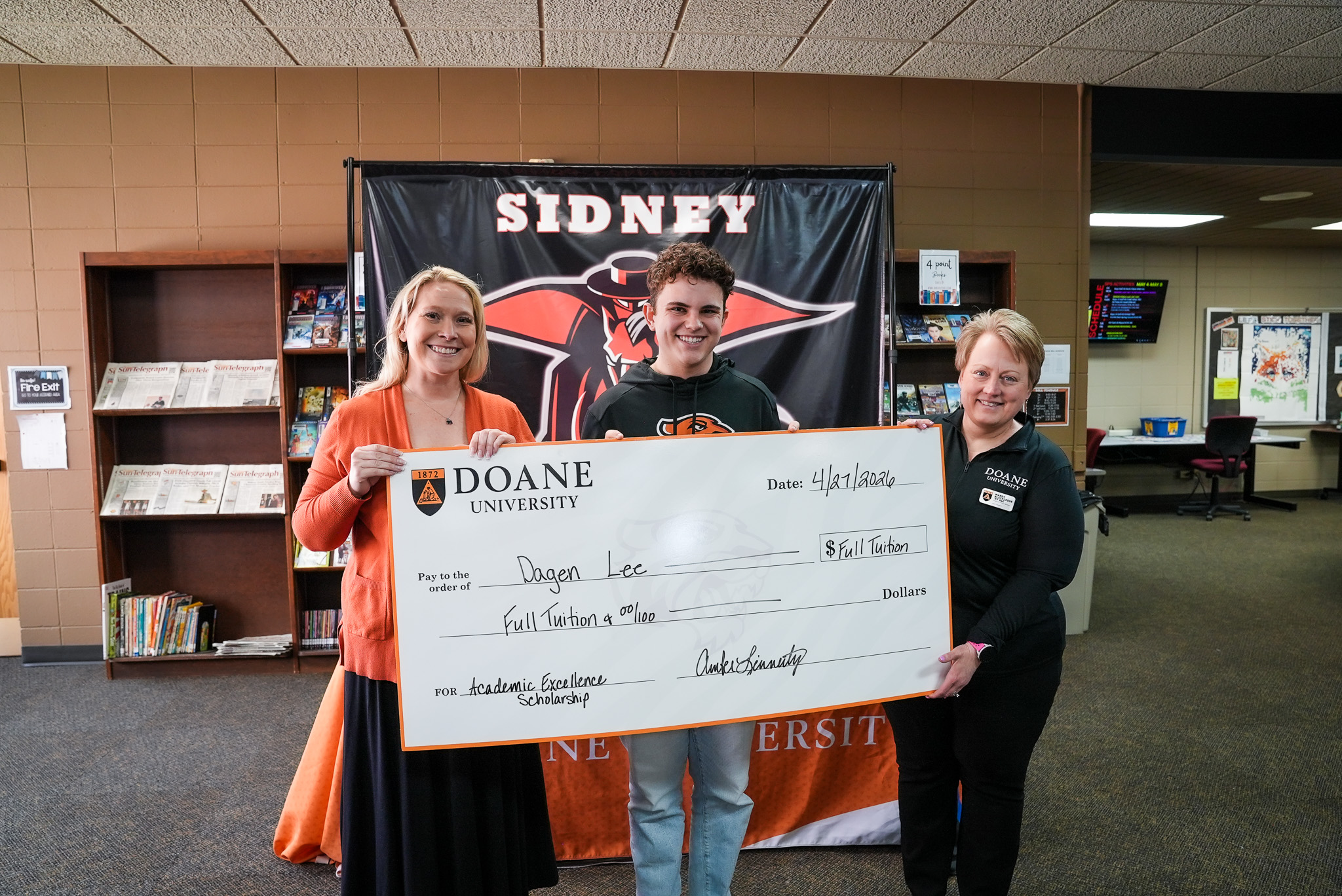 Dagen Lee with a check for the Academic Excellence Scholarship