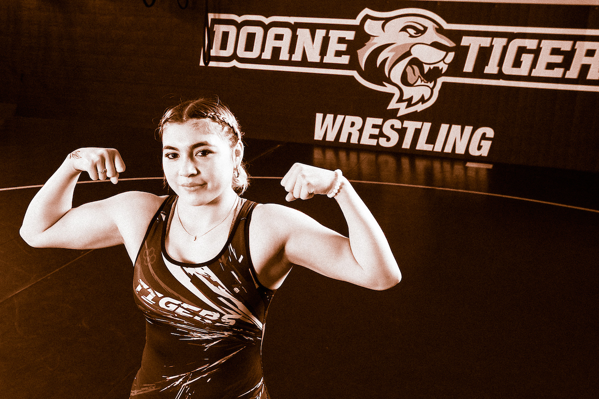 Cristelle Rodriguez flexes on the mats in Butler Gymnasium during a photoshoot. 