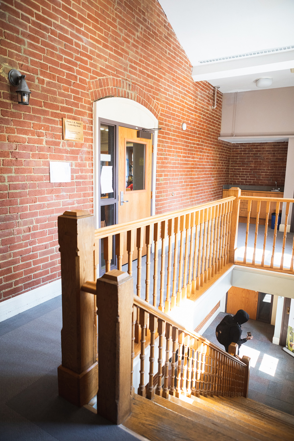 Image of the fifth floor of Gaylord Hall, looking down the stairs as a student comes up them.