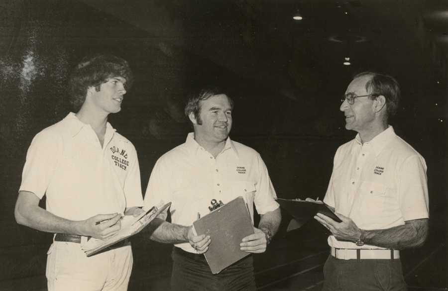 Fred Beile stands with other Doane track and field coaches