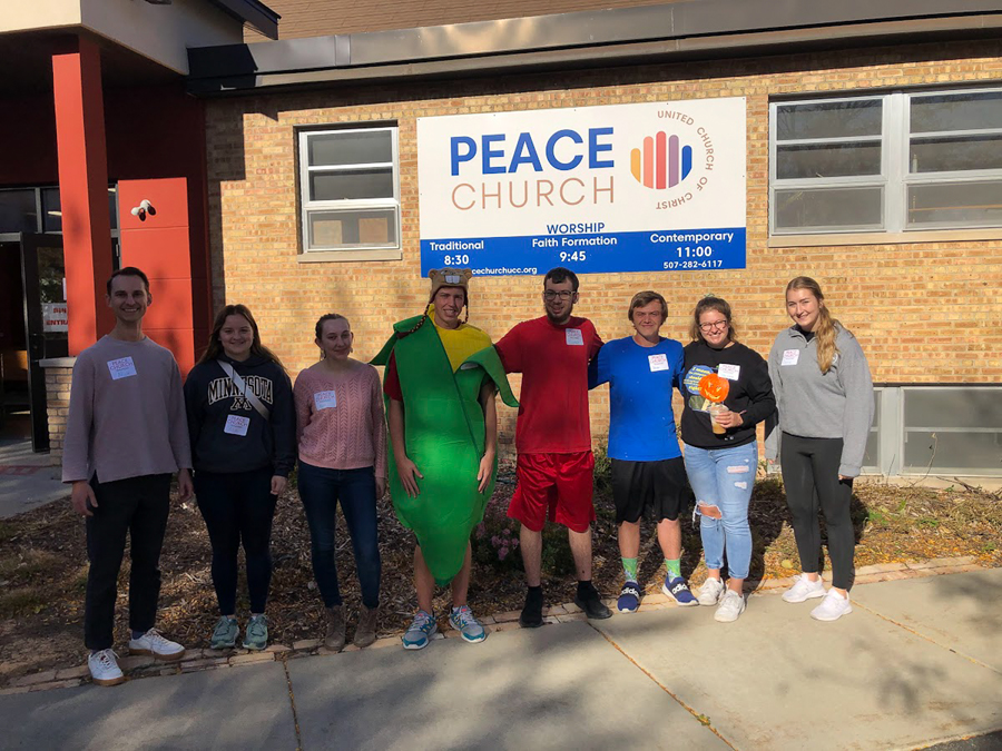 Nick Knopick, (far left) assistant director of leadership and service, stands with students outside of Peace Church in Rochester, Minnesota. Students helped run Drag Queen Bingo night at the church during their time in the city on alternative fall break. 