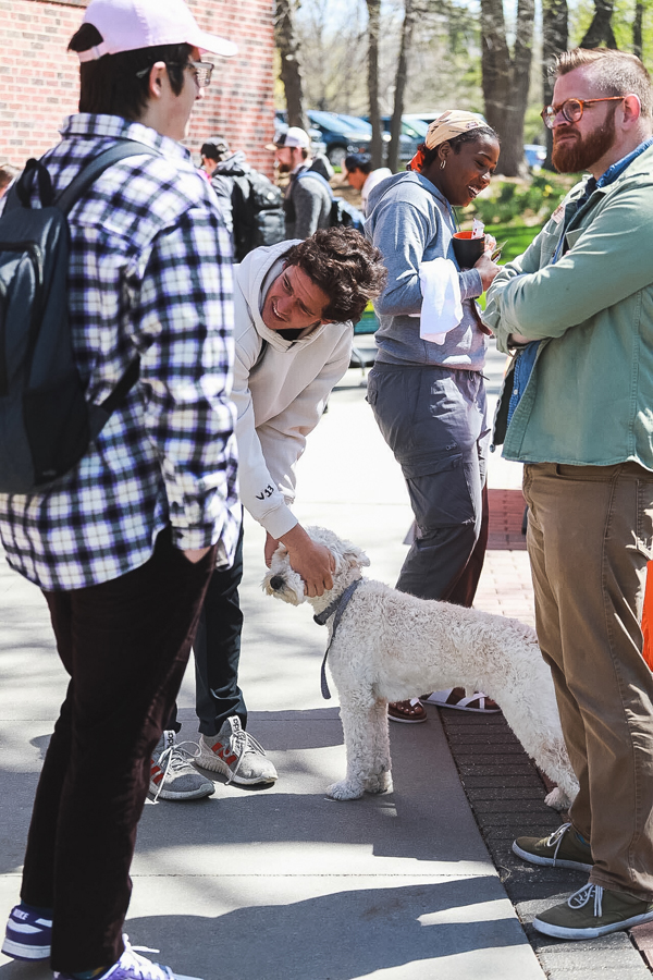 Georgie gets a head pat from students at the Academic Success Center's booth outside of Perry Campus Center during DeStress Fest in the week before finals.