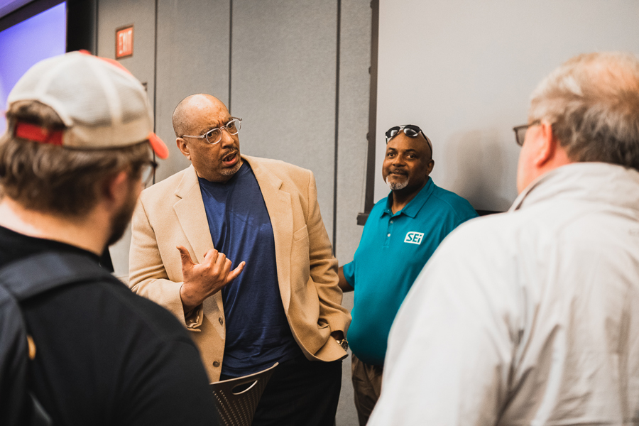 Jerry Gamble '88 speaks with students and fellow Doane alumni Mike Barnes '91 and Cody Vance '82.