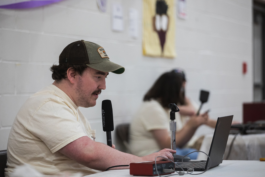 Trey Porter speaks into a microphone from Fuhrer Fieldhouse. He livestreamed coverage of the Doane/Saline County Relay for Life event on April 14 for 91.1 KDNE.