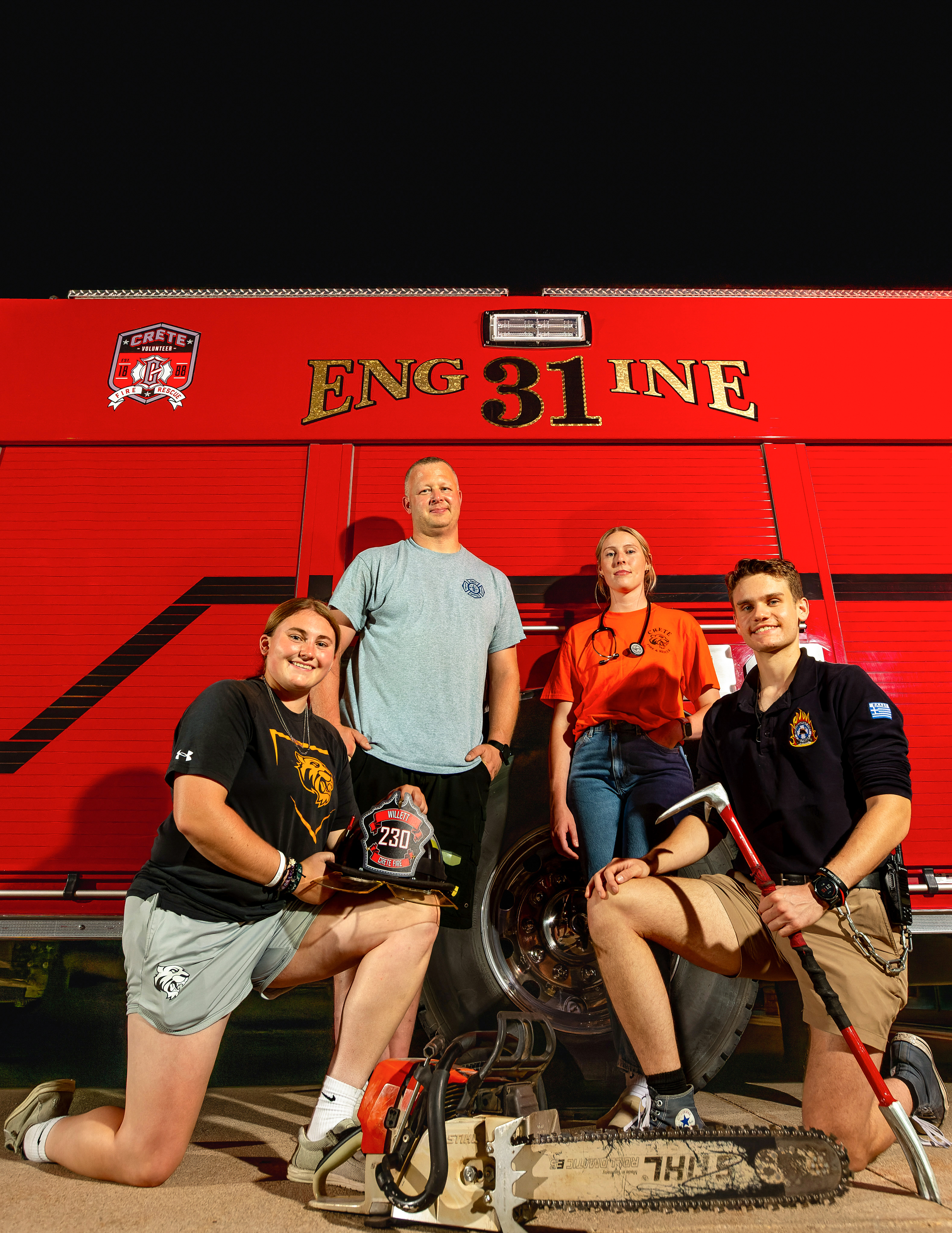 members of Crete Volunteer Fire Department pose by a fire truck