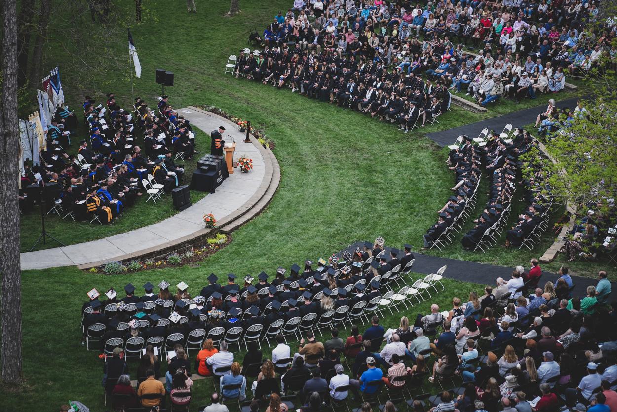 An aerial view of Cassel Theatre filled with graduates and their families for spring commencement.