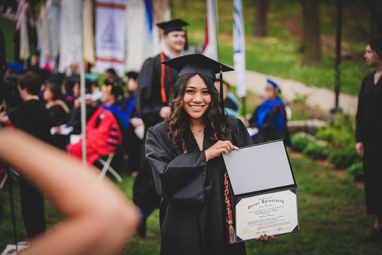 Lilly Shatford-Adams poses with her diploma during the afternoon commencement ceremony on May 8, 2022.