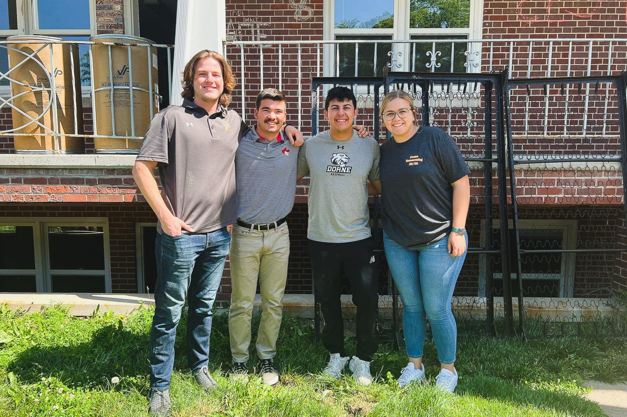 Nina Theiler '19 (right) stands next to Tigers on Tour Riley Reyes ‘24, Robb Foote ‘24 and Justin Nevells ‘24 in front of the Quads as they move bed frames for donation. 