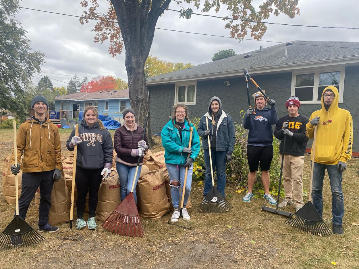 Nick Knopik, (far left) assistant director of leadership and service, stands with students participating in Doane's Fall 2022 alternative break. Students went to Rochester, Minnesota to volunteer, including at several group homes for adults with developmental disabilities, where they interacted with residents and helped clean up yards and trees before winter. 