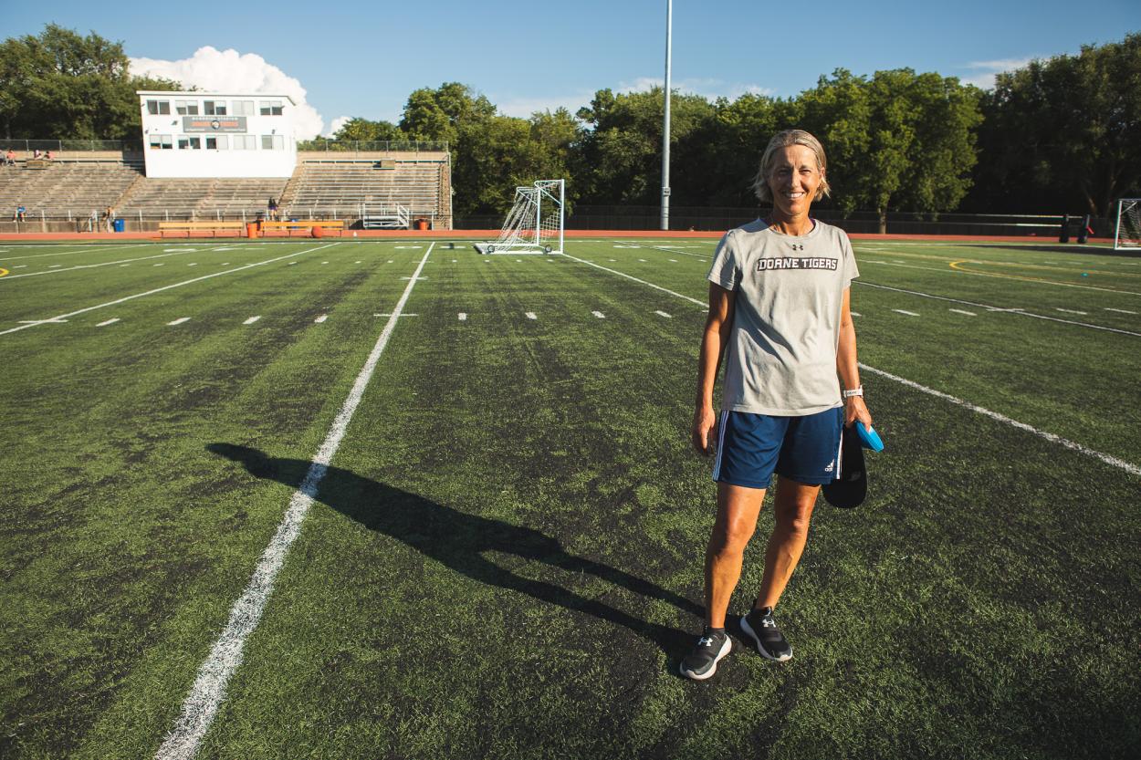 Head coach for the Doane women's soccer team, Jennifer Kennedy-Croft stands on the turf at Memorial Stadium at Doane.