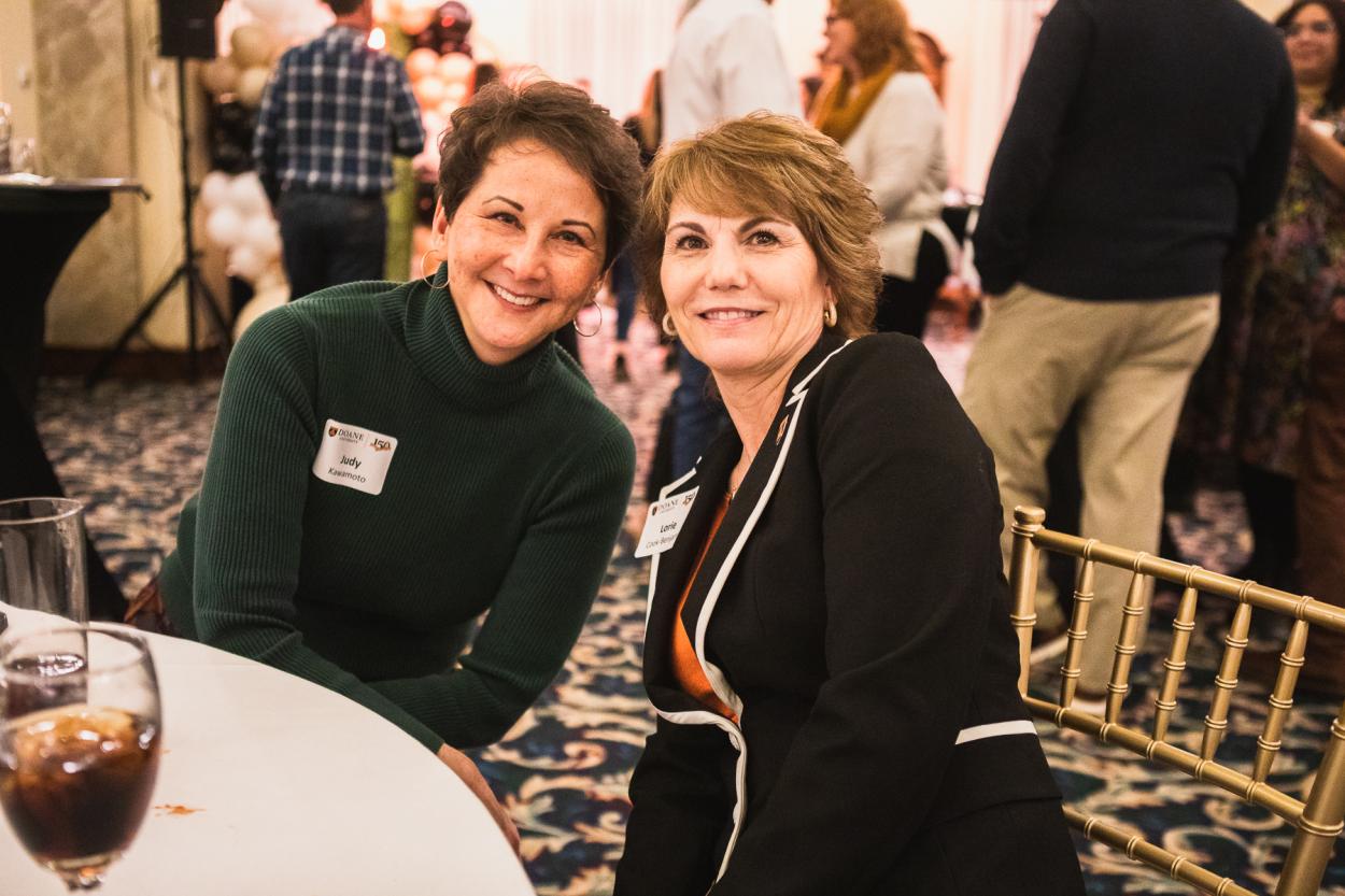 Dr. Judy Kawamoto sits next to Lorie Cook-Benjamin, chief academic officer, at Doane's Employee Appreciation Event on March 11.
