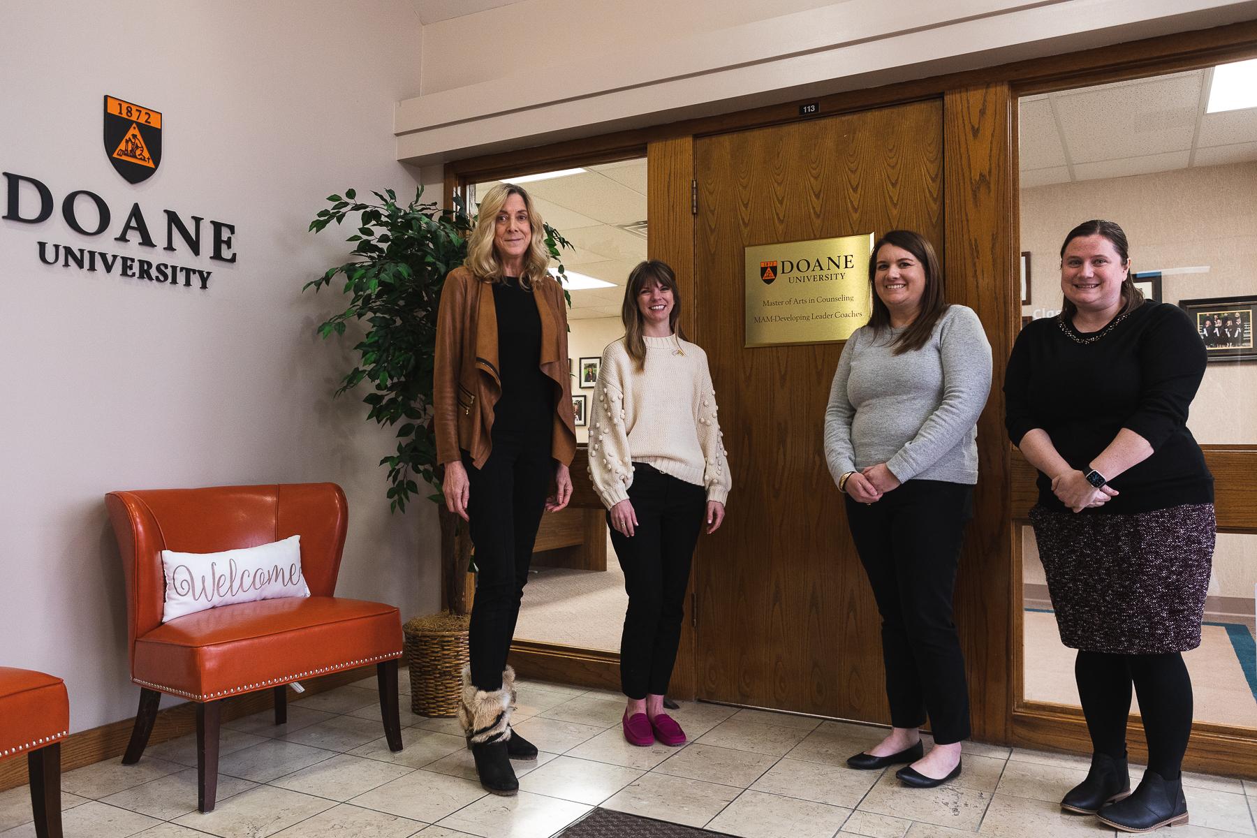 Master of Arts in Counseling faculty Jean Kilnoski, Courtney East, Arden Szepe and Andrea McGrath stand outside the program's offices on Doane's Lincoln campus location.