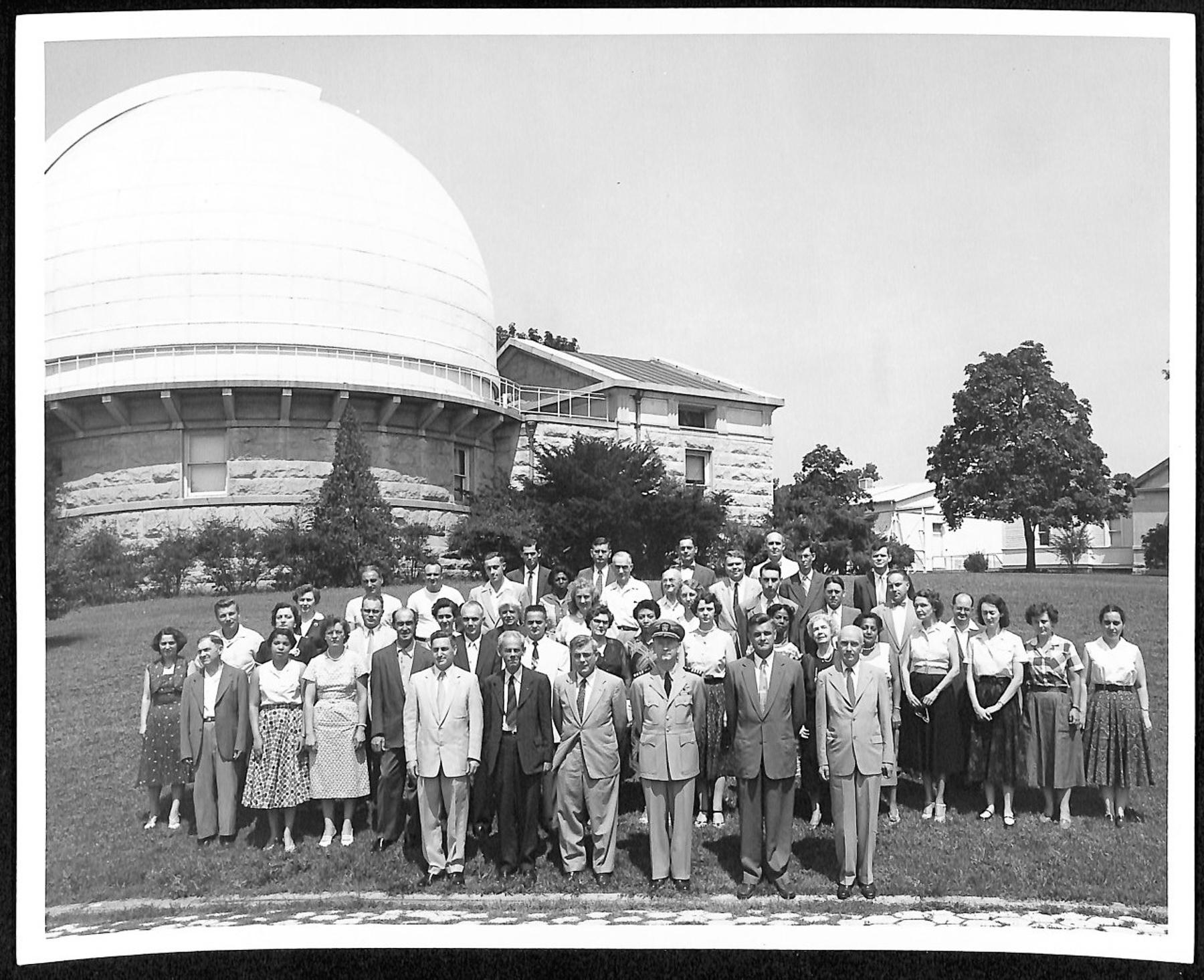 Employees of the U.S. Naval Observatory stand posed in front of one of the transit buildings. 