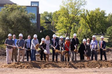 Members of Doane University's Leadership Team, Clark & Enersen and Sampson Construction participate in a groundbreaking ceremony for the university's newest residence hall. Sampson Construction provided shovels and hardhats for the event. 