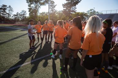 Women's soccer coach Jennifer Kennedy-Croft addresses her players during a practice.
