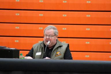 Cody Vance sits behind a mic at Haddix as the public address announcer at Doane University 